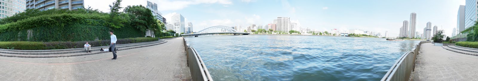Tokyo restaurant reviewer looking at sumida river and eitai bridge